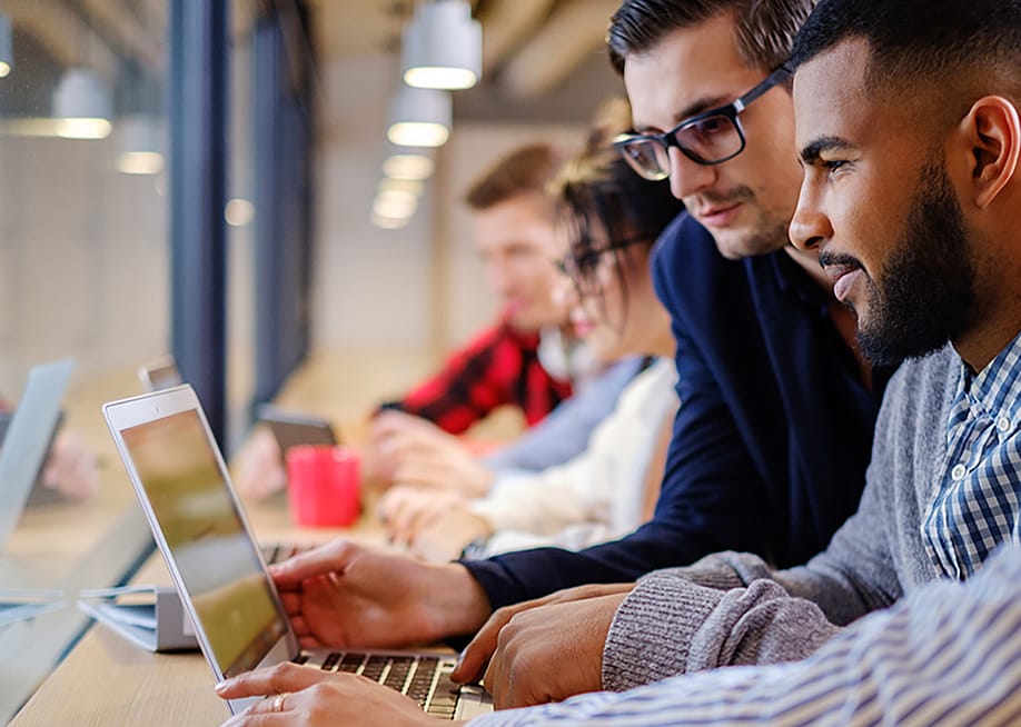Colleagues discussing work project ideas at the office. — Nejron Photo // Shutterstock