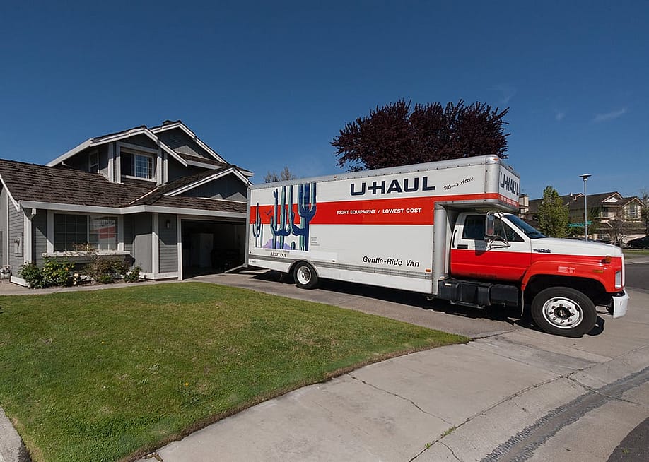 A U-Haul truck parked in front of a house. — ZikG // Shutterstock