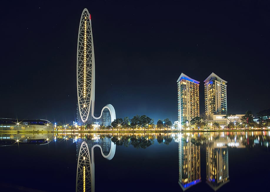 Marriott and Hilton Hotel buildings reflecting on the lake's surface at night in Batumi, Georgia. — naskami // Shutterstock