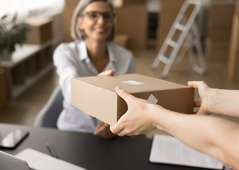Customer receiving her package from delivery. — fizkes // Shutterstock