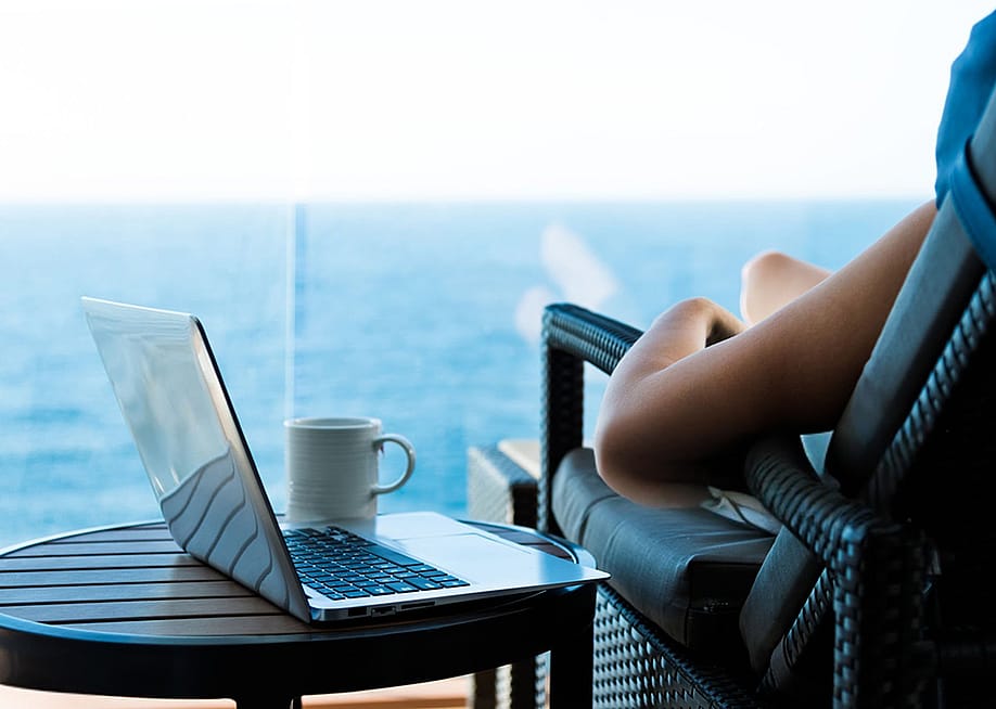 Person relaxing with laptop and cup of coffee on their side. — baona jnr // Shutterstock