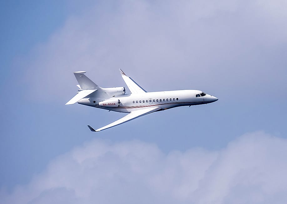 A Skyfirst Dassault Falcon 7X luxury plane in the air. — MiscMedia // Shutterstock