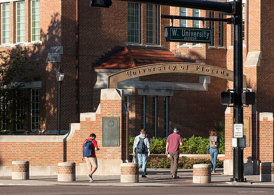 Students walking through an entrance gate at the University of Florida. — Sharkshock // Shutterstock