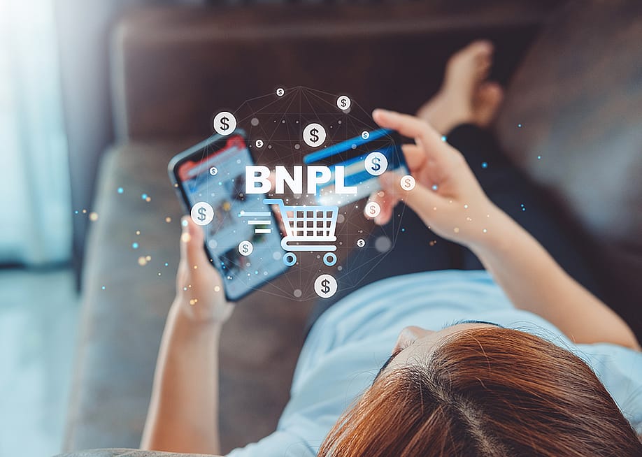 Woman shopping online illustrated with Buy Now Pay Later graphics. — Joyseulay // Shutterstock