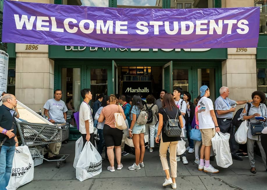 Students welcomed with a huge banner as they go back to school. — rblfmr // Shutterstock