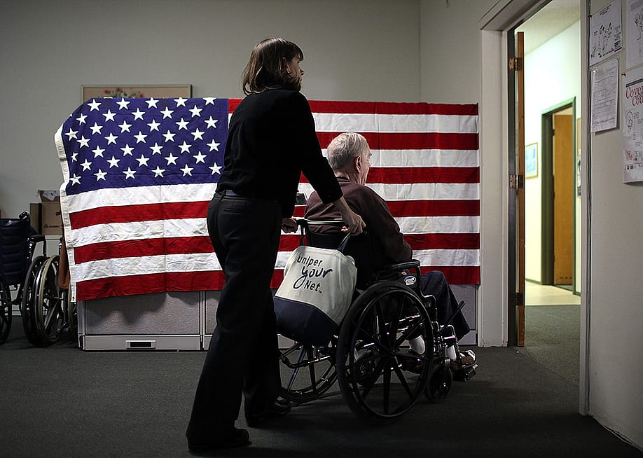 Physical therapist Joan Collins (L) pushes Fred Lear in a wheelchair after he had a physical therapy session at the Lifelong Medical Marin Adult Day Health Care Center on February 10, 2011 in Novato, California. — Justin Sullivan // Getty Images