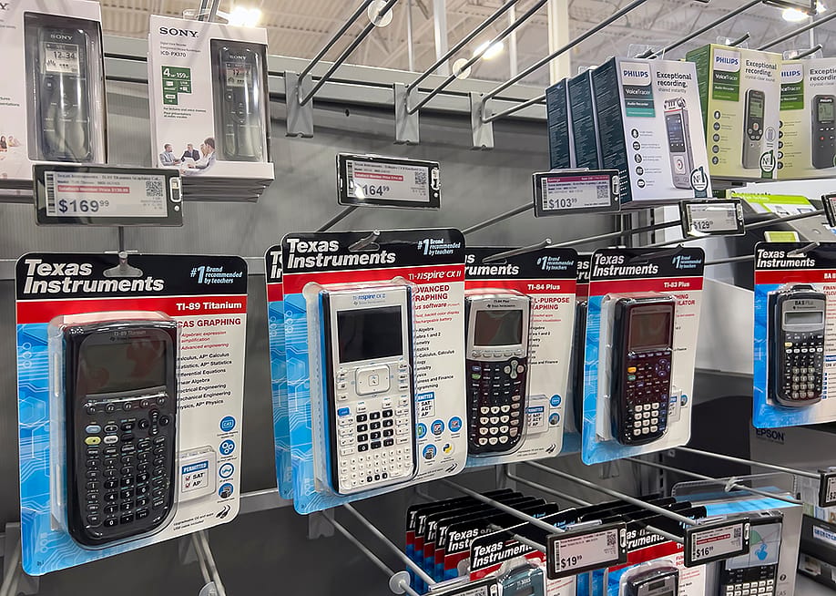 Graphing calculators displayed for sale inside an electronics store. — Colleen Michaels // Shutterstock
