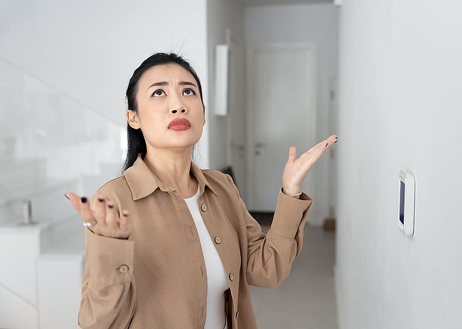 A confused female homeowner about air conditioning. — fizkes // Shutterstock