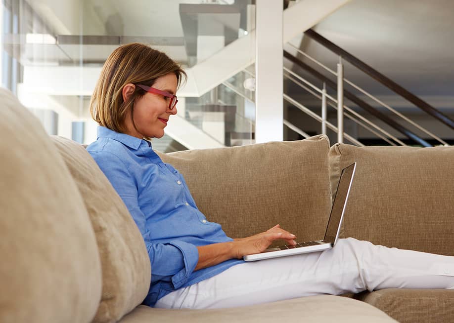 A businesswoman working at home with her laptop. — mimagephotography // Shutterstock