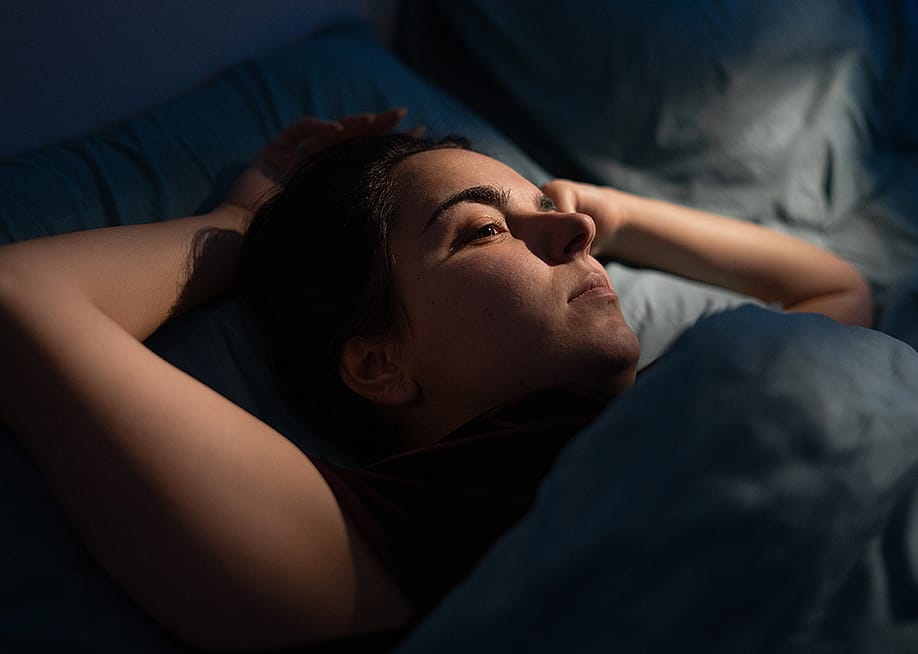 A woman drifts into sleep at night. — Lysenko Andrii // Shutterstock