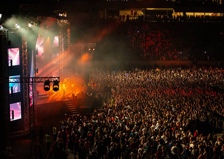 A sold out stadium during a concert performance. — Ruslan Lytvyn // Shutterstock