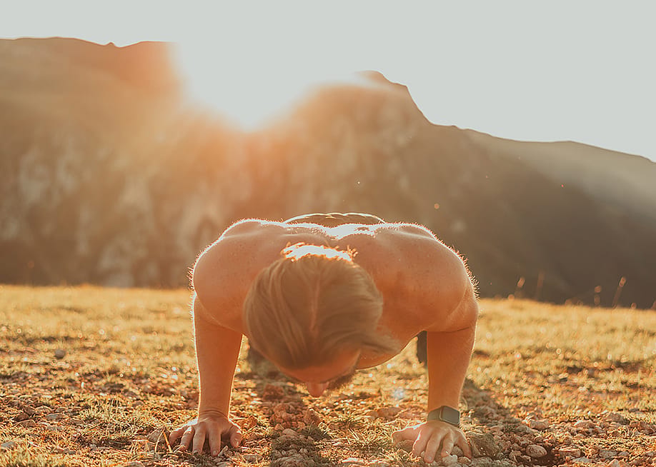 An athlete doing push-up exercises early in the morning. — MZStock // Shutterstock