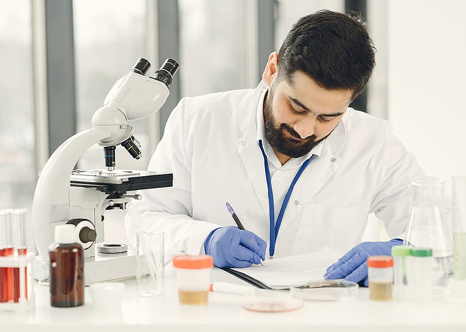 A medical technologist completing diagnostic results of patients in a clinical laboratory. — Oleggg // Shutterstock