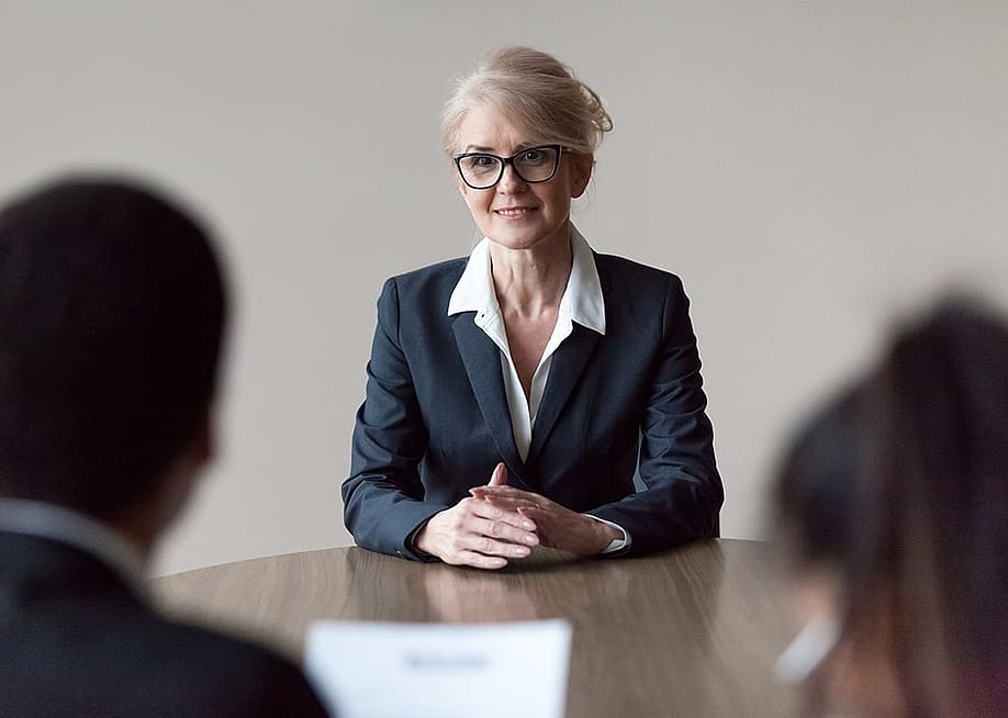 A senior HR recruiter interviewing candidates for a role. — fizkes // Shutterstock