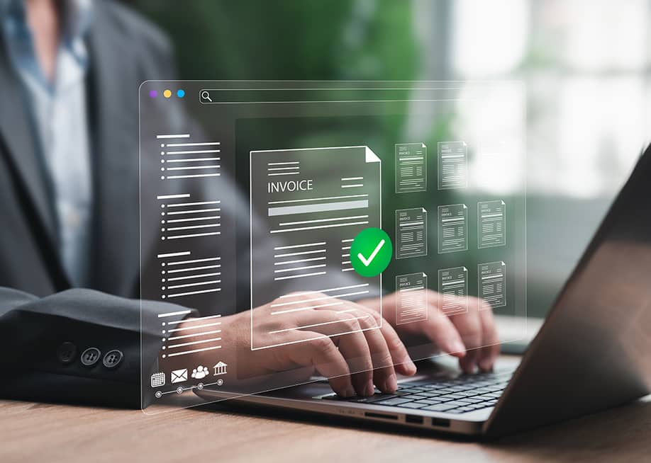 A finance officer processing an automated and digital invoice in an office laptop. — NONGASIMO // Shutterstock