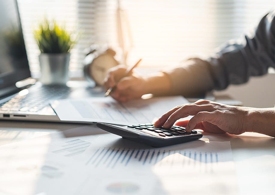 An entrepreneur calculating a business' balances before tax deduction planning. — Pormezz // Shutterstock