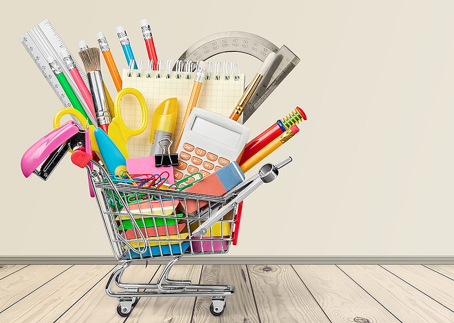 A mini shopping cart filled with different school materials and supplies. — Billion Photos // Shutterstock