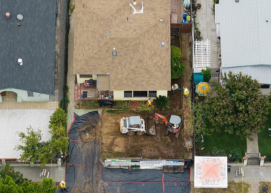 Aerial view of a house in the Boyle Heights neighborhood of Los Angeles gets cleaned of lead contamination from the shuttered Exide plant on Friday, June 9, 2023. — Myung J. Chun // Los Angeles Times via Getty Images