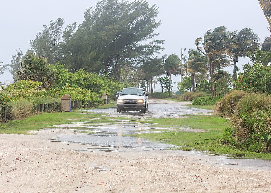 A car on the road as a hurricane passes over Florida. — Nicole Glass Photography // Shutterstock
