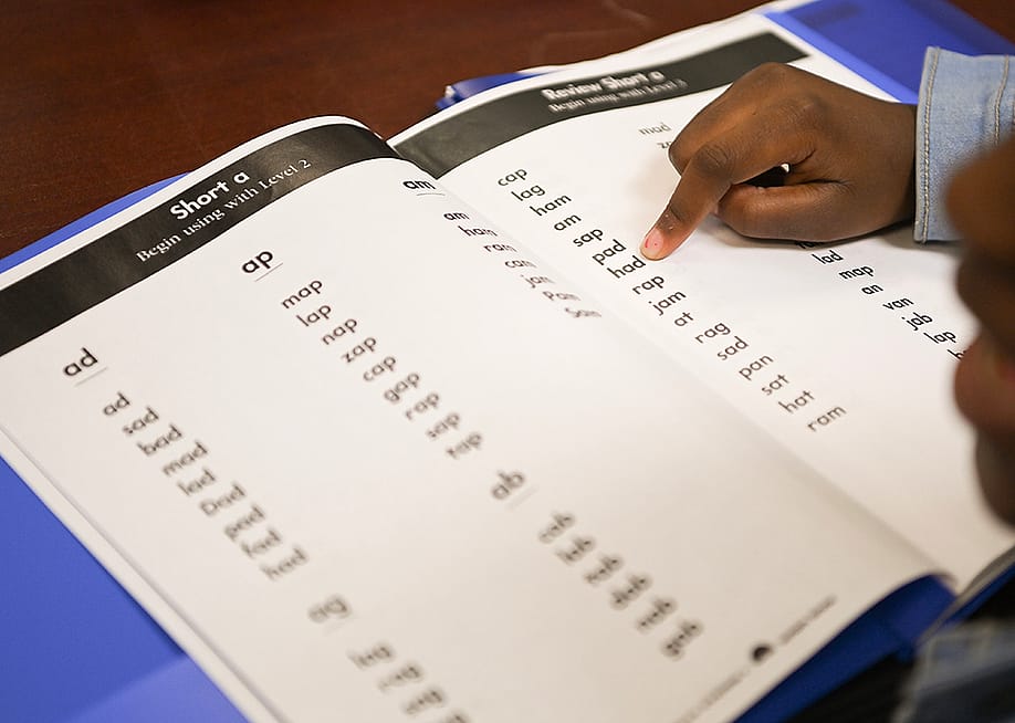 Notasulga Elementary School second grader Jordan Jackson follows along in her book with her teacher during a reading intervention exercise on March 15, 2023, in Notasulga, Alabama. — Julie Bennett // The Washington Post via Getty Images