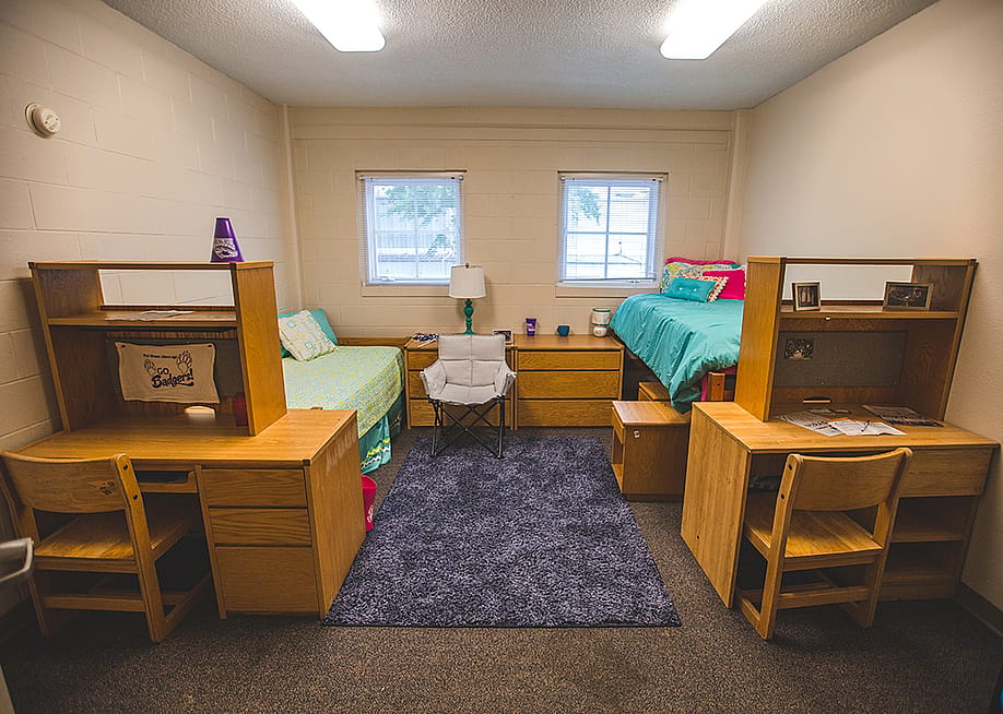 A college dorm room with two single beds. — Tiago Pestana // Shutterstock