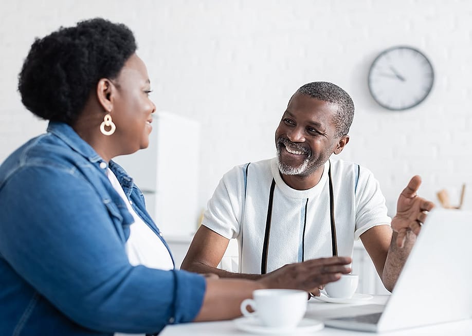 A black couple engaged in a healthy discussion at home. — LightField Studios // Shutterstock
