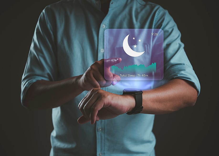 A person using a smartwatch with sleep tracking application for rest cycle and quality analysis. — khunkornStudio // Shutterstock