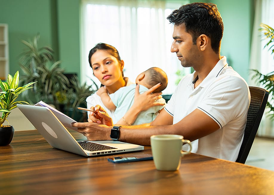 Parents with their infant child viewing and managing household expenses. — StockImageFactory.com // Shutterstock