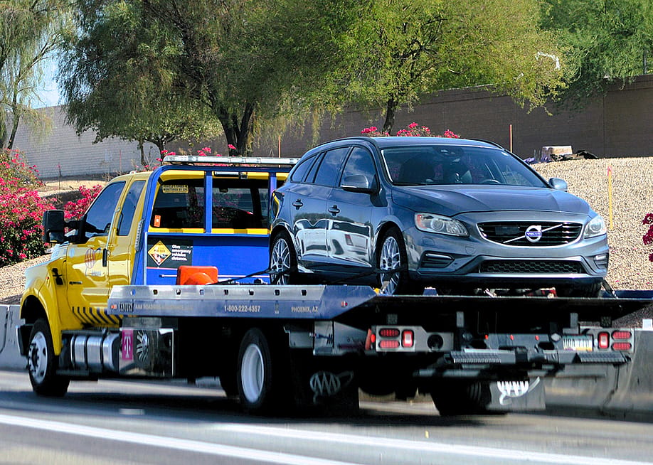 A roadside assistance truck picks up a car to service. — Around the World Photos // Shutterstock
