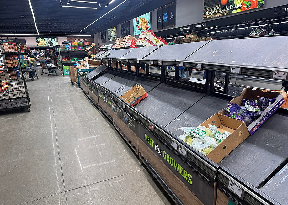 Empty shelves of fresh produce seen inside a grocery store. — gg5795 // Shutterstock