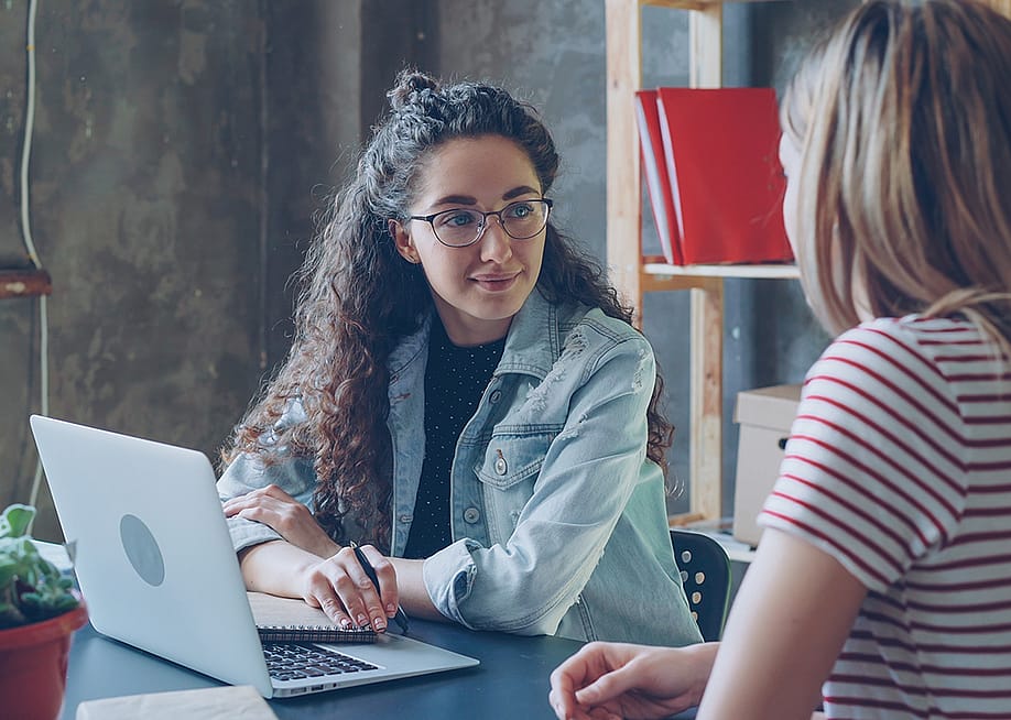 Two female entrepreneurs engaged in a discussion — silverkblackstock // Shutterstock