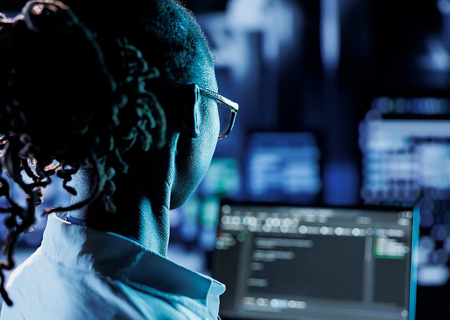A trained cyber professional running code or program in a computer. — DC Studio // Shutterstock