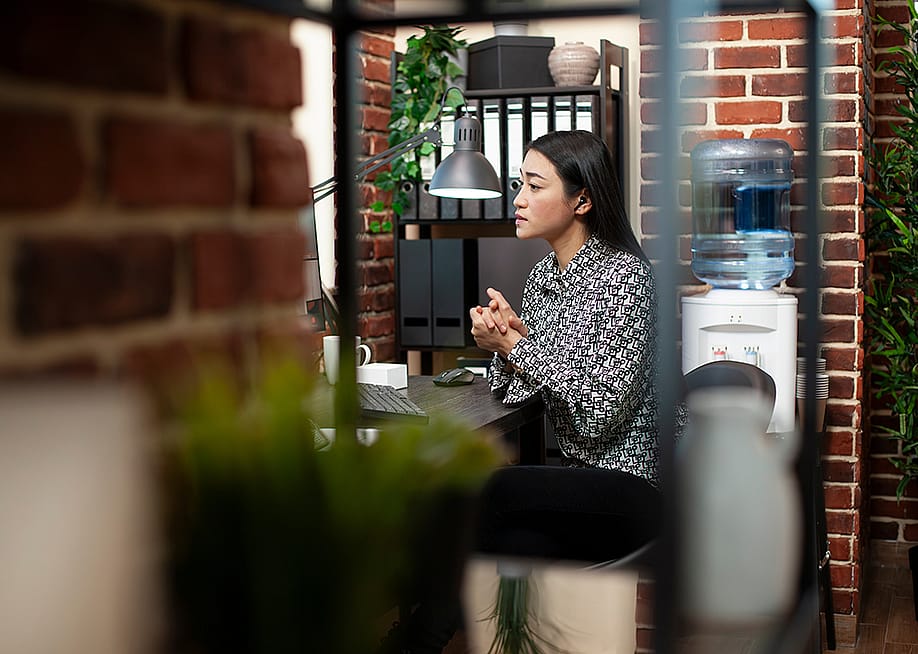 A content marketer listening to an online meeting session from an office room. — DC Studio // Shutterstock