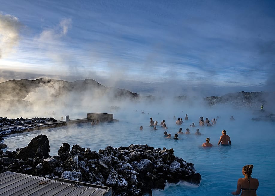 People swimming in the Blue Lagoon geothermal spa during winter in Grindavík, Iceland. — pio3 // Shutterstock