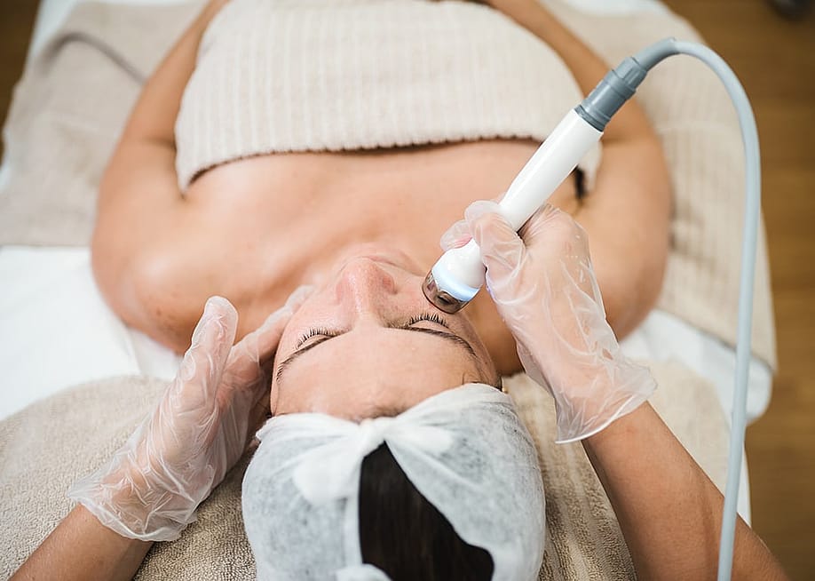 An aesthetician giving a professional facial treatment. — Ma74e // Shutterstock