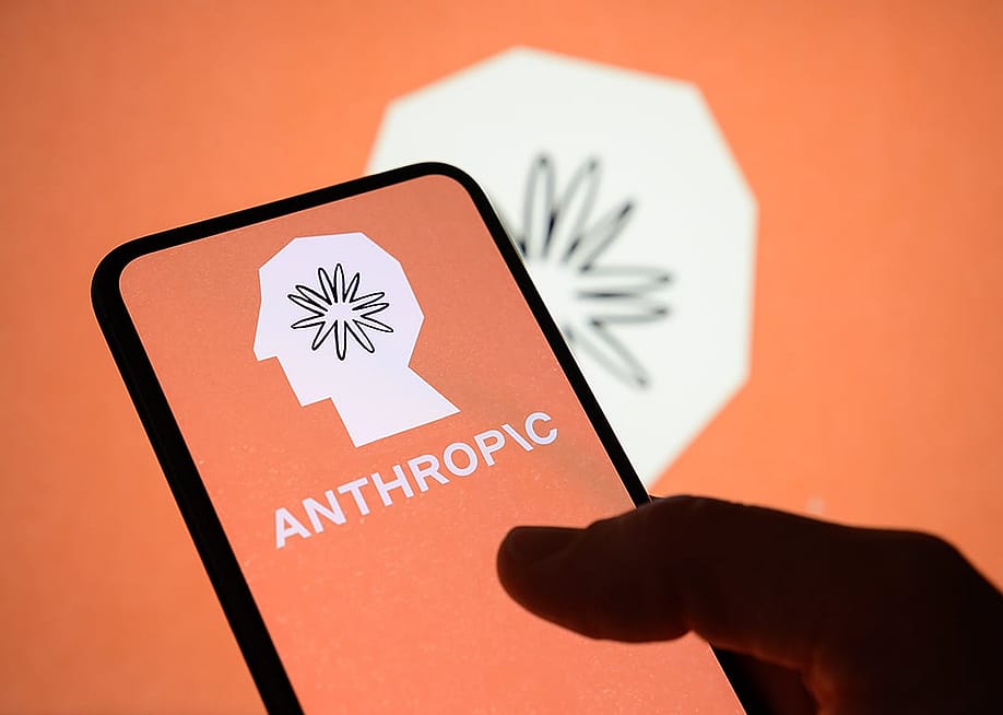 The Anthropic logo displayed from a smartphone's screen with the company's brand in the background. — Samuel Boivin // NurPhoto via Getty Images