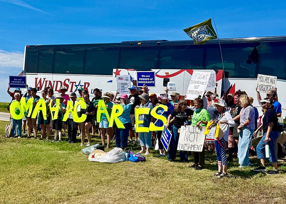 Protestors traveled 10 hours round trip on a bus road to attend an Aug. 15 rally within eyeshot of a McCook, Nebraska-based U.S. Immigration and Customs Enforcement detention center that started holding migrants last November. The rally marks a year since Gov. Jim Pillen’s administration announced a partnership with ICE to house immigrant detainees. — Cindy Gonzalez // Nebraska Examiner