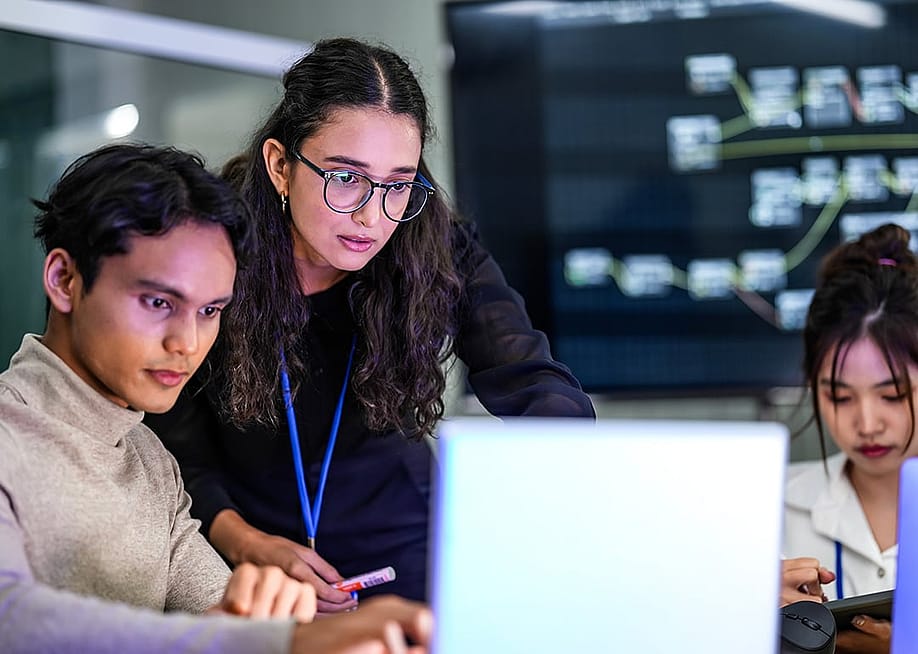 A focused group of developers working on a coding project. — ultramansk // Shutterstock