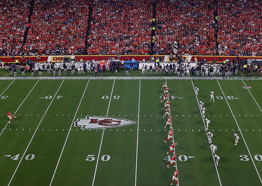 Kansas City Chiefs' No. 7 Harrison Butker kicking the ball on the games opening kickoff across Baltimore Ravens players at the Arrowhead Stadium in Kansas City, Missouri, USA. — Aaron M. Sprecher // Getty Images