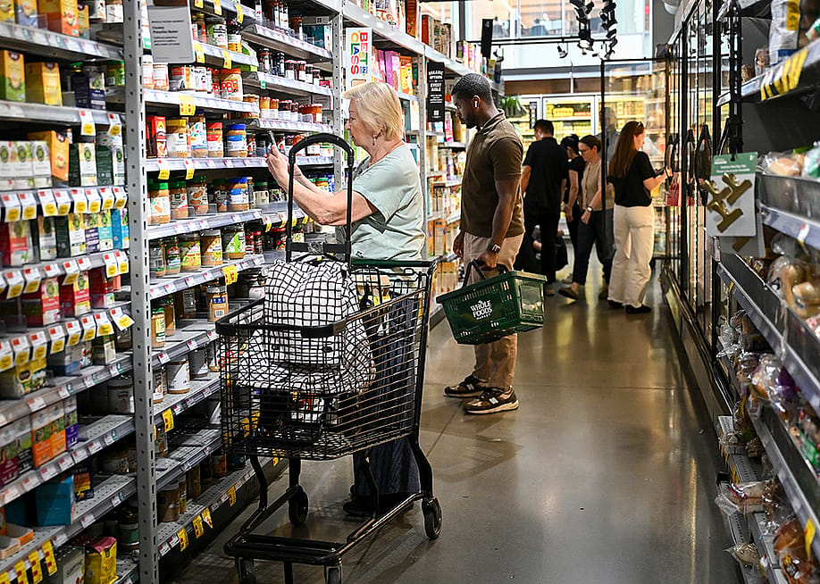 People shopping for grocery items at a Manhattan supermarket in New York City, USA. — ANGELA WEISS // AFP via Getty Images