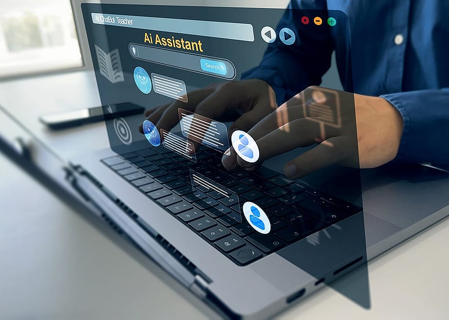 A conceptual graphic of a person using an AI chatbot on a laptop. — Mer_Studio // Shutterstock