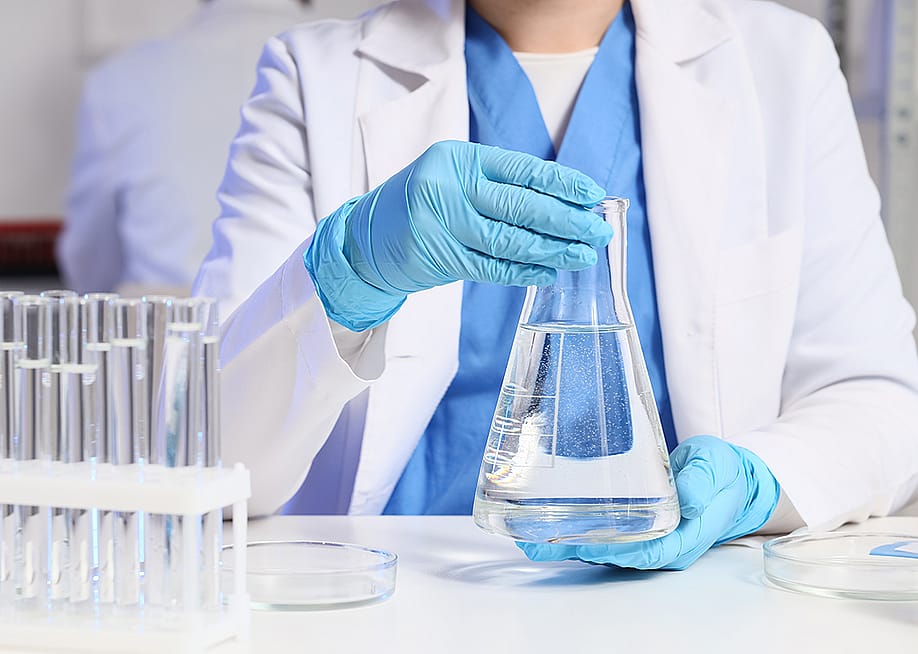 A female scientist working on water samples in a laboratory. — Pixel-Shot // Shutterstock