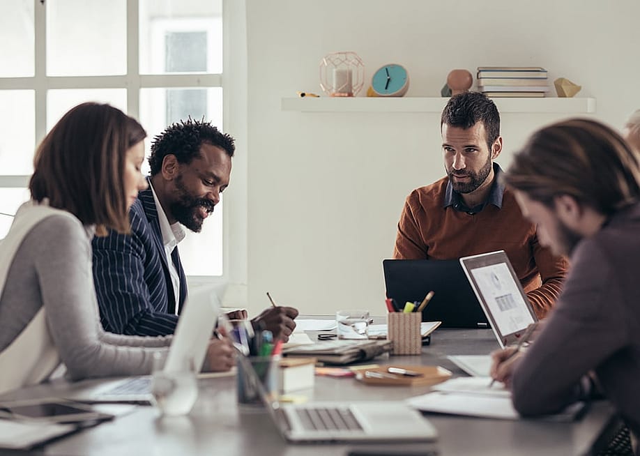 A business team engaged in a discussion during meeting. — LStockStudio // Shutterstock