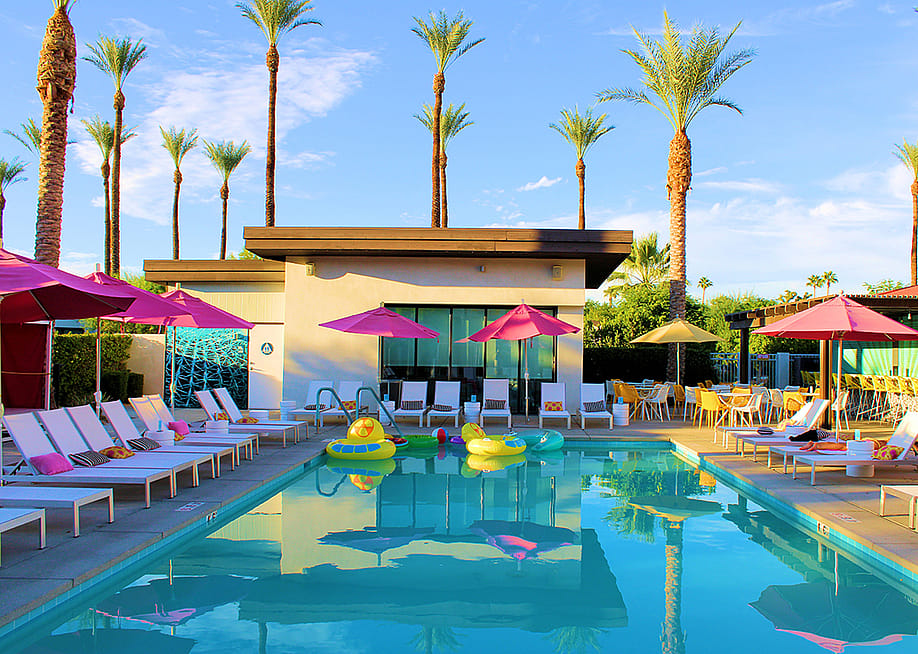 A view of the poolside in a luxury resort in Palm Springs, California. — photojohn830 // Shutterstock