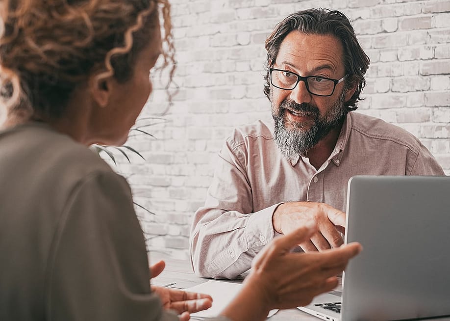 A consultancy professional engaged in discussion with a client. — simona pilolla 2 // Shutterstock