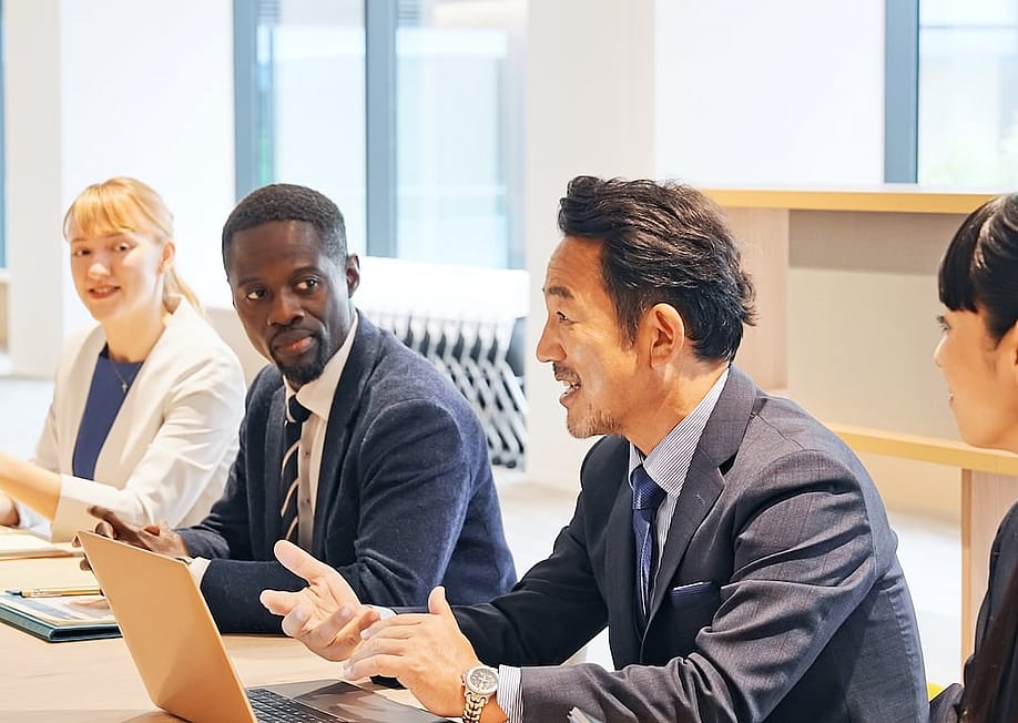 A multinational team engaged in a business meeting. — metamorworks // Shutterstock