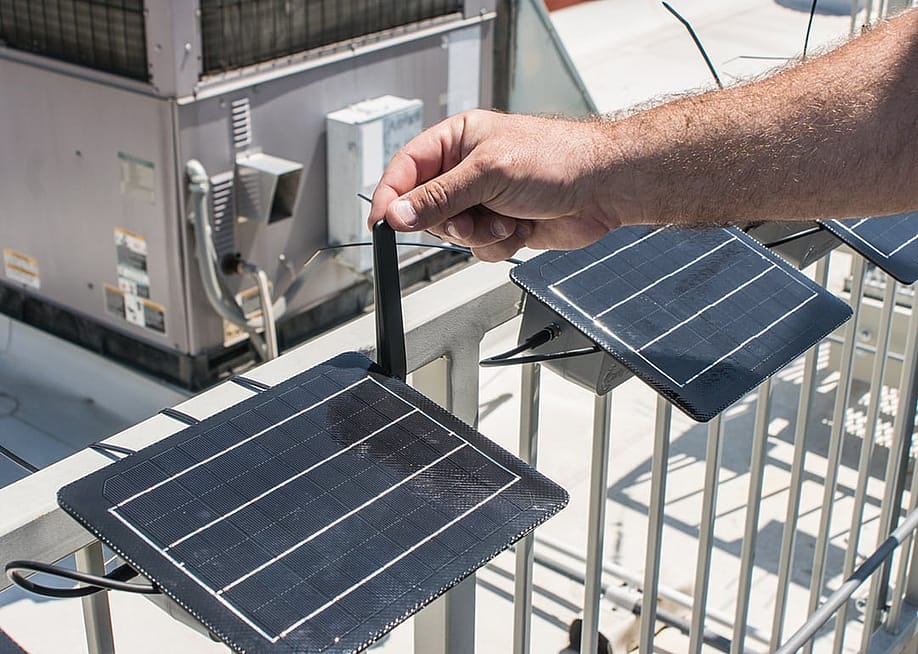 A California official calibrates rooftop air monitoring equipment used to track local air pollution. — Courtesy of the California Air Resources Board
