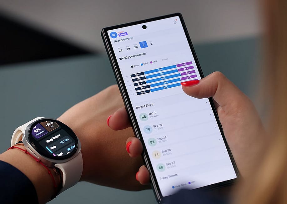 Woman tracking heartbeat and sleep quality in a smartwatch and mobile app. — Andrey_Popov // Shutterstock