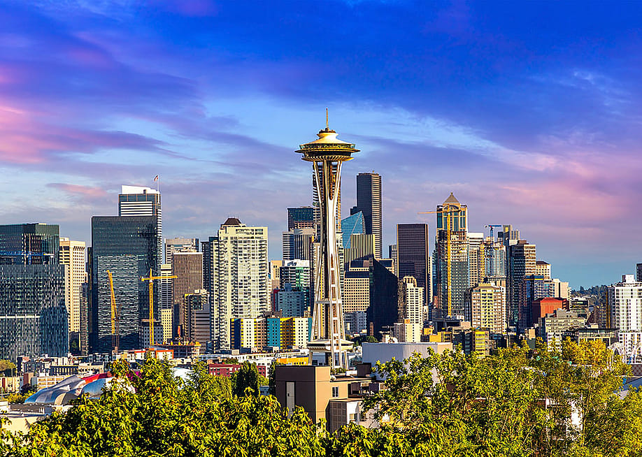 A panoramic view of Seattle cityscape at sunset. — Sergii Figurnyi // Shutterstock