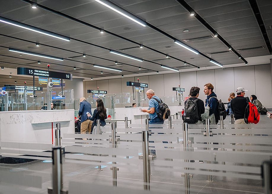 Passengers waiting in line at an immigration line at the airport. — shulers // Shutterstock
